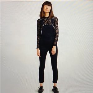 Levi’s black skinny overalls